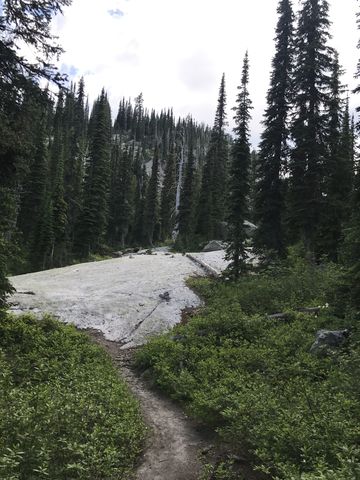 The trail crosses large granite slabs marked with cairns