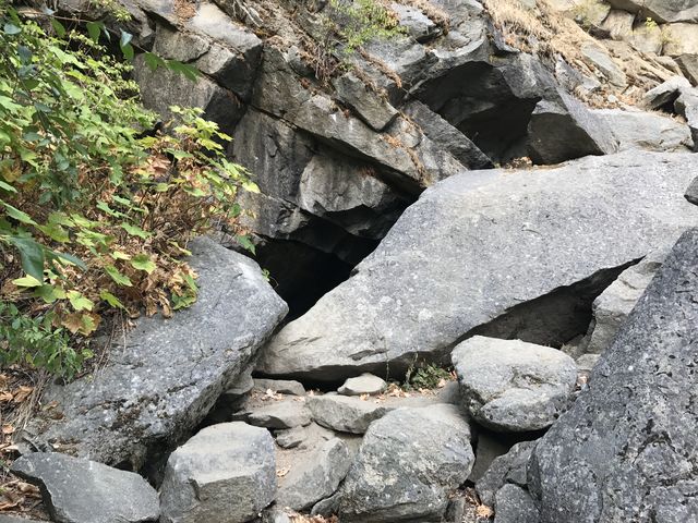 The tunnel is partially blocked by a rock slide