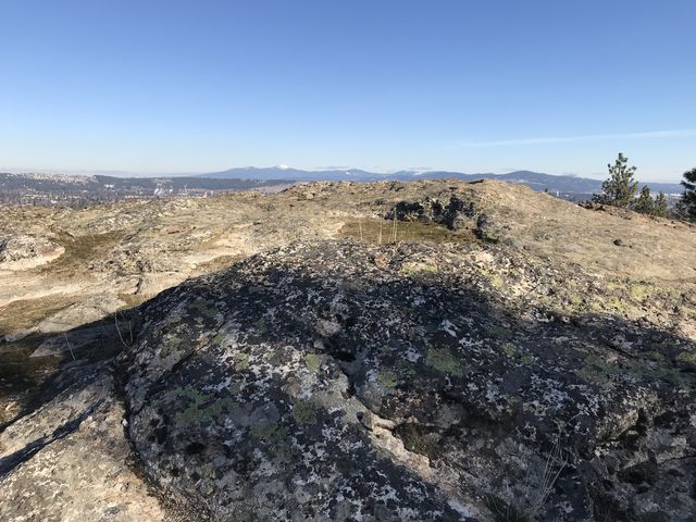 A rocky plateau with views of the Selkirk Mountains in the distance