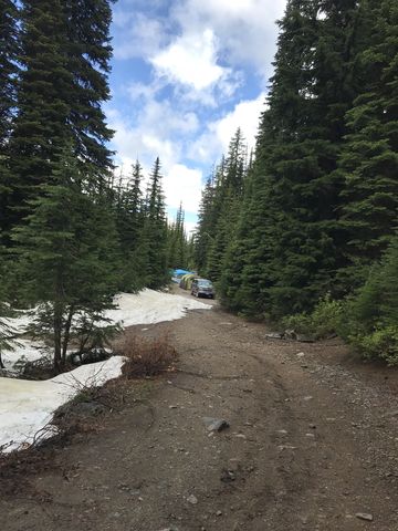 Campers on the forest road, ahead of a 2-3 foot snow berms